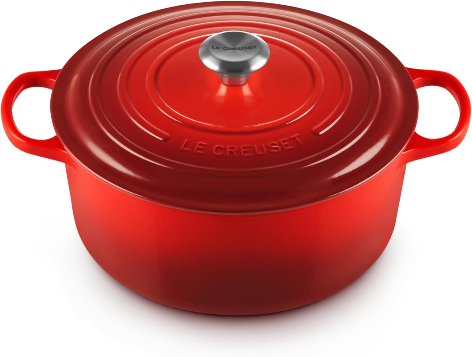 Colorful Le Creuset Dutch ovens on a shelf